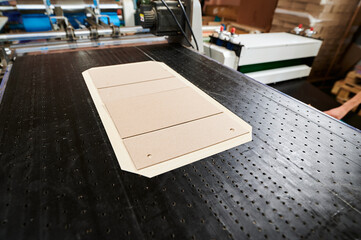 Efficient production of decorative packaging in a busy factory showcasing box lid blanks on the...