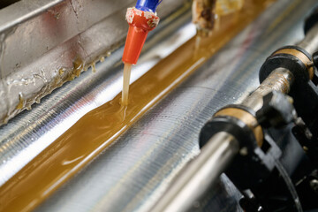 Precision application of glue using advanced machinery for seamless adhesion in manufacturing processes