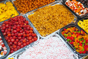 assortment of dried fruits, colorful sweets, candies and chewable marmalade on oriental market in Asia