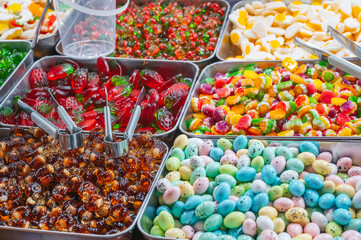 assortment of colorful marmalade and chewable candies on counter in the store