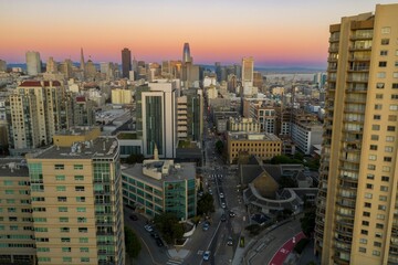 Aerial view of San Francisco, California, USA, at sunset. Skyscrapers and buildings fill the skyline as cars drive along the streets below. Lower Pacific Heights.