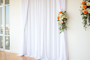 white backdrop with flowers and greenery on it