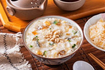 Minced pork congee with preserved egg on the table 