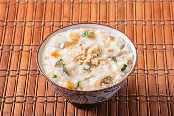 Minced pork congee with preserved egg on the table 