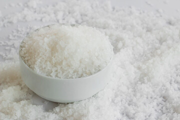 Close up taken of coarse-grained rock salt heap in white bowl
