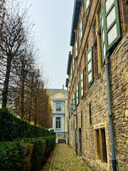 Fototapeta premium Charming winter alleyway with brick houses and green hedges in Ghent, Belgium