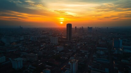 Fototapeta premium Sunset over urban skyline cityscape aerial view vibrant colors peaceful atmosphere