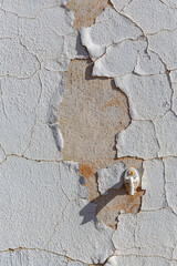 Closeup of cracked and pealing paint on an abandoned building