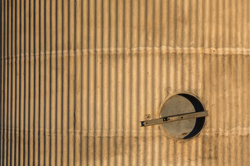 Fluted concrete wall and inspection hatch on a grain silo