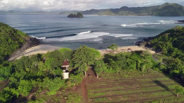 Flyover quiet empty sand beach on tropical Lombok Indonesia shore