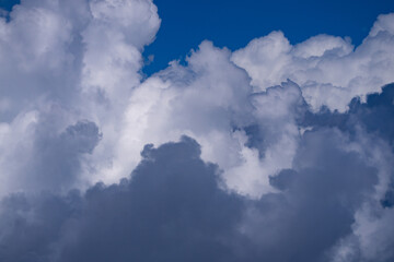 Dreamy cloudscape. Clouds background for design. Many clouds. Puffy cumulus cloud drifting. Light and shadow in clouds. Sky with white clouds.