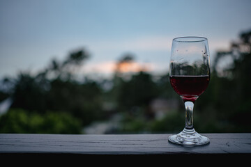 Red wine in glass at dusk on the coast 