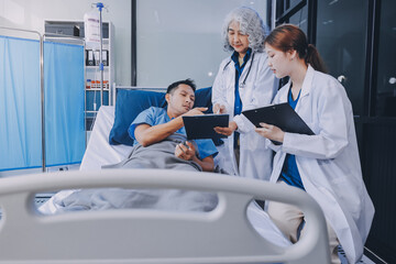 Nurse giving assistance to senior patient with disease in bed. Medical assistant and doctor doing healthcare checkup for pensioner with oxygen tube and IV drip bag in hospital ward.
