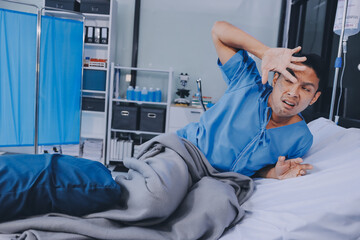 Lonely man silhouette sitting on the bed feeling depressed and stressed in the dark bedroom, Depression and anxiety disorder concept