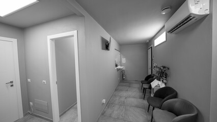 Minimalist medical reception area with clean surfaces, lighting, and patient-friendly layout