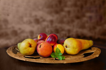 green juicy background.still life of fresh fruit on a carved wooden tray