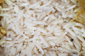 Cooked white rice served in a bowl with spices and herbs