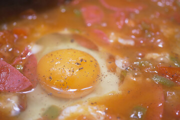 Fresh egg cooked with vegetables in savory sauce