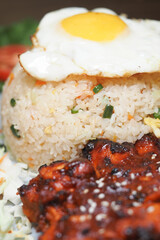 Delicious fried rice with grilled chicken and fried egg served hot