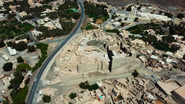 Aerial view of Bahla Fort, Oman! This 13th-century UNESCO fortress is a symbol of Oman's rich history. Watch now!