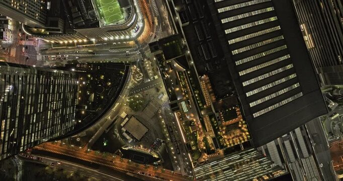 Osaka Japan Aerial v97 vertical top down view flyover Kita Ward, capturing the illuminated buildings and streets, and major railway station in downtown - Shot with Mavic 3 Pro Cine - Oct 9th 2023