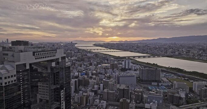 Osaka Japan Aerial v78 flyover Oyodonaka capturing downtown cityscape and bridges across Yodo river connecting Fukushima and Nishiyodogawa wards at sunset - Shot with Mavic 3 Pro Cine - Oct 9th 2023