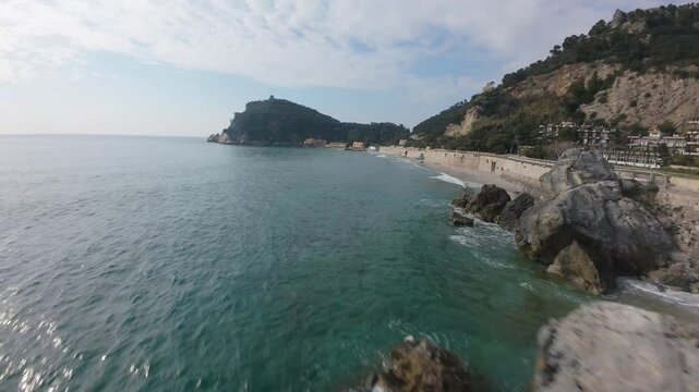 attention holding high-speed aerial flying close to the coastline in Spiaggia del Malpasso Italy near the roadside