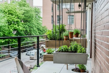 Modern Urban Balcony Garden: A chic urban balcony filled with small potted herbs, succulents, and hanging plants. Concrete planters and minimalist furniture create a stylish look.