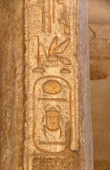 Vertical background with ancient Egyptian hieroglyphs on stone wall, Egypt, Africa. Backdrop with sandstone carving with hieroglyph. Mock up template. Copy space for text