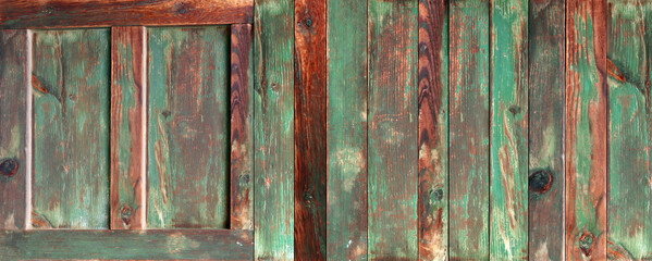 Texture of vintage wood boards with cracked paint of brown and green color. Horizontal retro background with old wooden planks of different colors