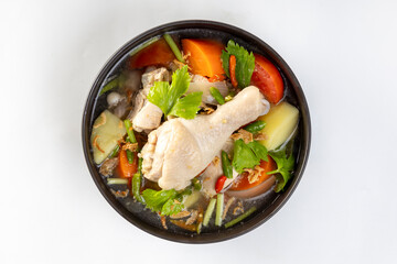 Sour and spicy chicken soup with potatoes, tomatoes, carrots, onions and vegetables.
