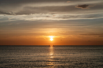 Two people on stand-up paddleboards, ocean sunset in Florida