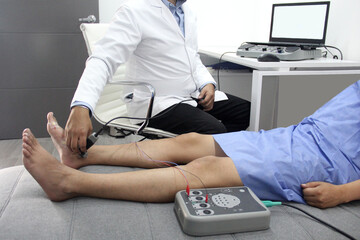 Electromyography and somatosensory evoked potentials in the legs of a young adult patient in the...