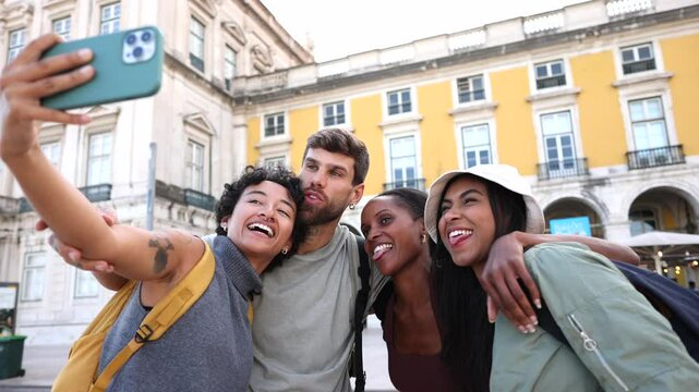 Happy tourists taking selfies in lisbon, portugal