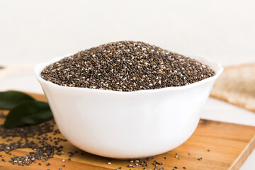 Chia seeds in bowl on colored background. Healthy Salvia hispanica in small bowl. Healthy superfood
