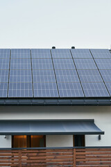 Eco-friendly house with rooftop solar panels under clear sky