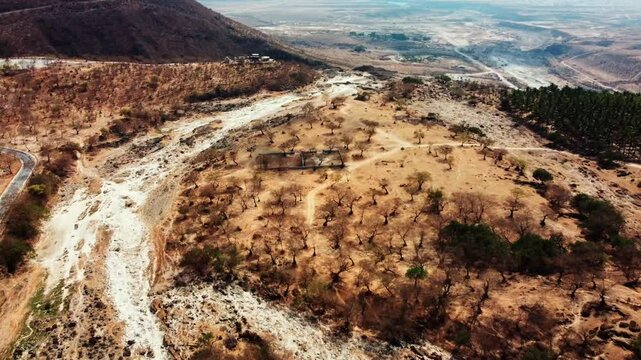 Soar above Wadi Darbat Valley in Oman! Enjoy this breathtaking aerial view of natural beauty. Watch now!