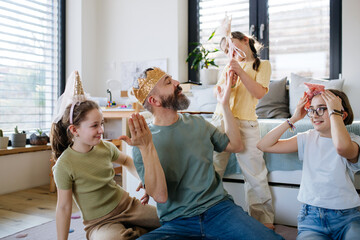 Portrait of father with three daughters at home.