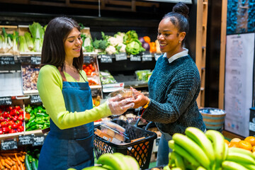 Saleswoman giving organic products to customer in supermarket