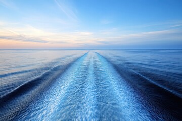 Serene Ocean Wave Trail Under Calm Blue Sky at Sunset