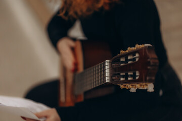 Close-Up of Guitar Playing with Focus on Headstock and Strings