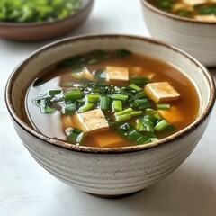 Delicious miso soup featuring tofu and green onions served in a ceramic bowl