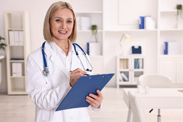 Weight loss. Smiling nutritionist with clipboard in clinic, space for text