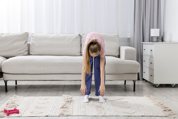 Little girl exercising at home, space for text. Morning routine