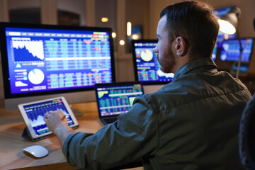 Financial trading specialist working in office at night
