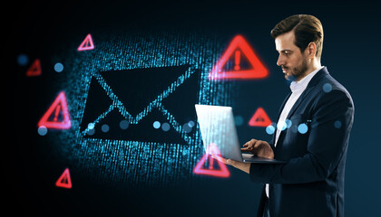 Businessman using laptop with glowing email security warning symbols on digital background.