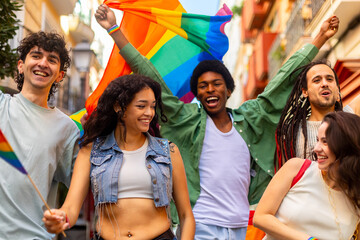 Young activists marching with rainbow flag for lgbtq plus rights