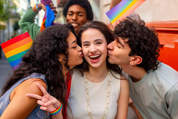 Obraz premium Friends kissing woman on cheek at pride parade