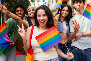 Young activists celebrating with rainbow flags at pride parade