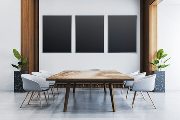 Modern office interior with wooden table, six chairs, and three black empty poster frames on wall in clean bright corporate meeting room. 3D Rendering